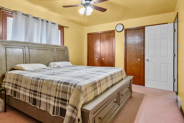 a spacious bedroom with a bed and a window