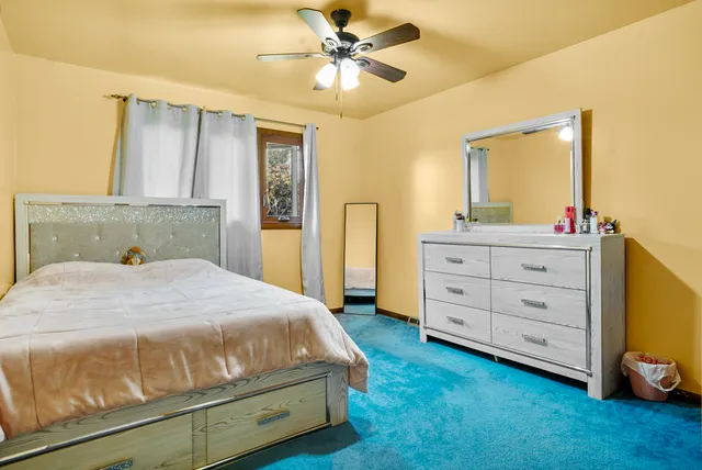 a bedroom with a bed and a dresser