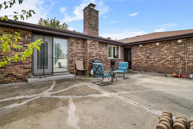 a view of a porch with furniture and floor to ceiling window