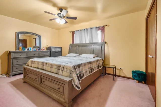 a bedroom with a bed dresser and a window