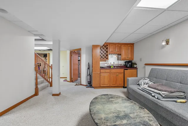 a living room with furniture and a kitchen
