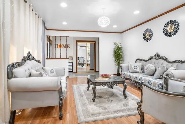 a living room with furniture and large window