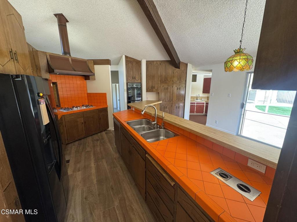 381 Laguna Terrace Simi Valley, CA 93065 - Photo 11 of 48 a view of a kitchen with a sink and wooden floor