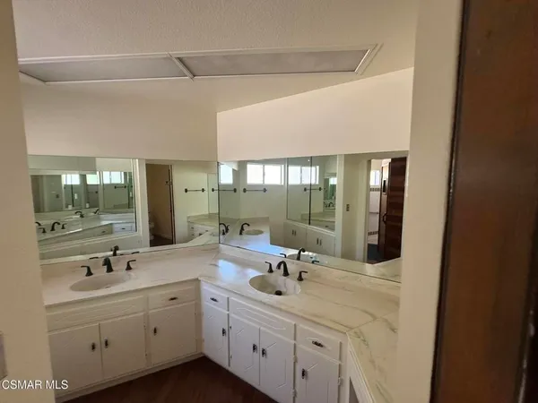 a bathroom with a double vanity sink mirror and double