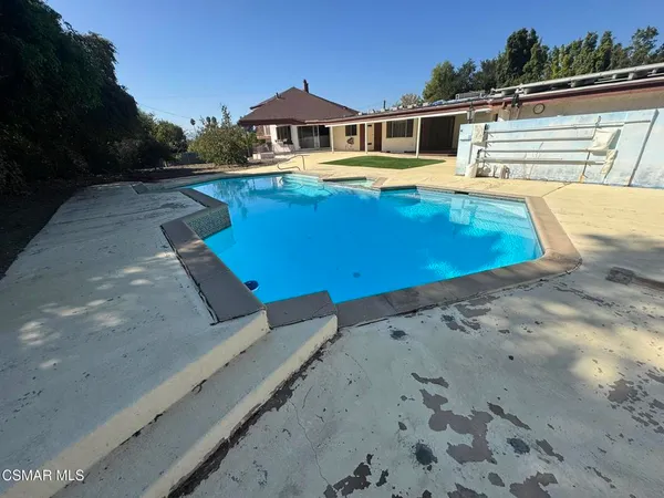 a view of a swimming pool with an outdoor seating