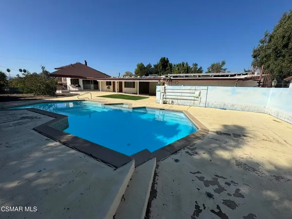 a view of a swimming pool with an outdoor seating