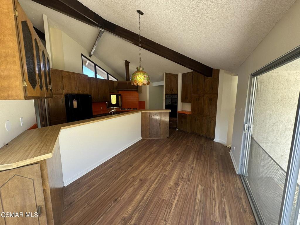 381 Laguna Terrace Simi Valley, CA 93065 - Photo 7 of 48 a view of a kitchen with a sink and wooden floor