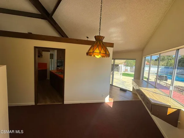 a hallway with a large window and couch