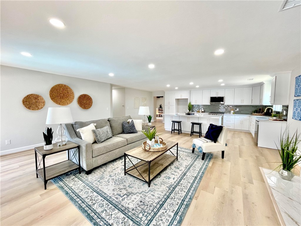 a living room with furniture kitchen view and a table