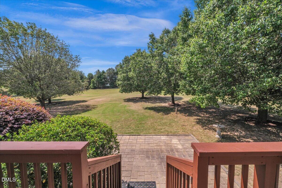 2908 Oak Bridge Drive Raleigh, NC 27610 - Photo 39 of 47 a view of a yard with plants and a bench