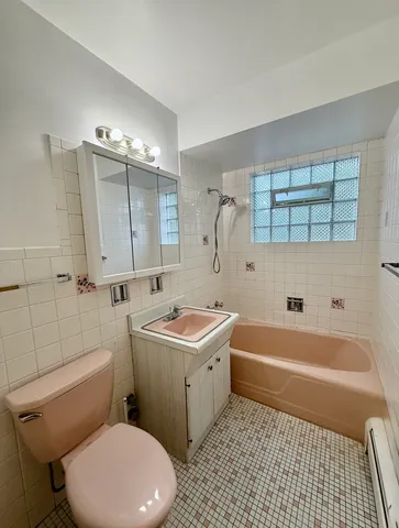 a bathroom with a sink a toilet and bathtub
