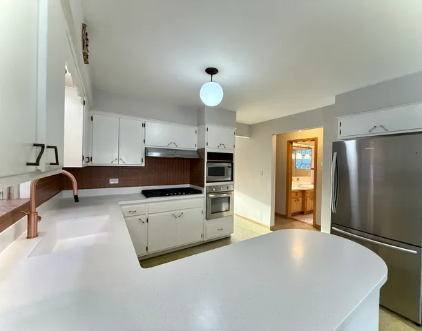 a kitchen with a refrigerator and a sink