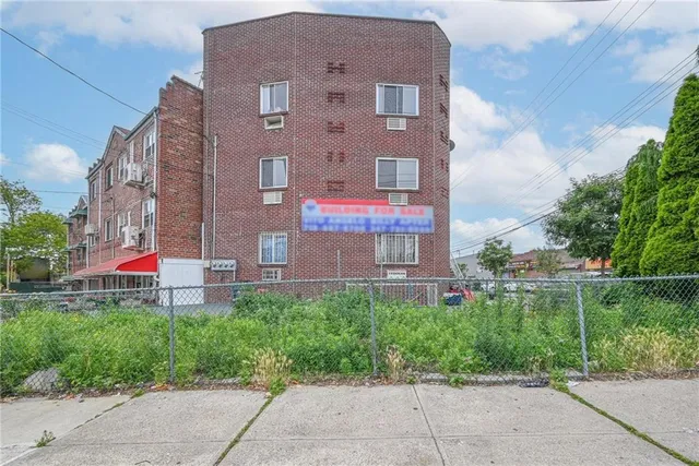 a view of a brick building next to a yard