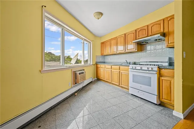 a kitchen with stainless steel appliances granite countertop a stove and a sink