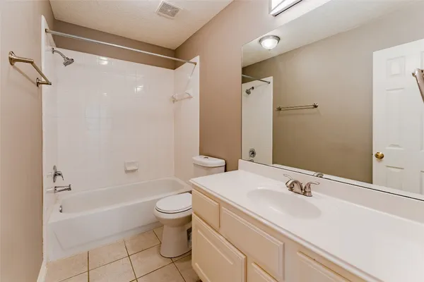 a bathroom with a sink toilet vanity and shower