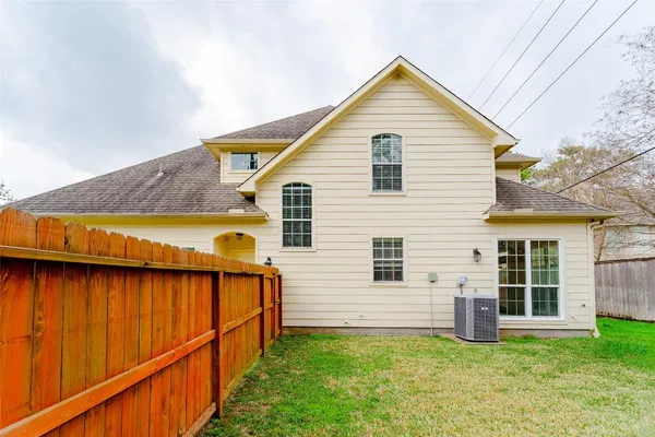 a view of a house with wooden fence