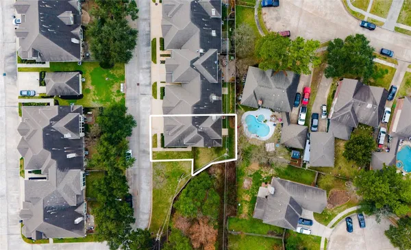 an aerial view of multiple houses with yard