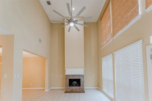 a view of a livingroom with a fireplace and a ceiling fan