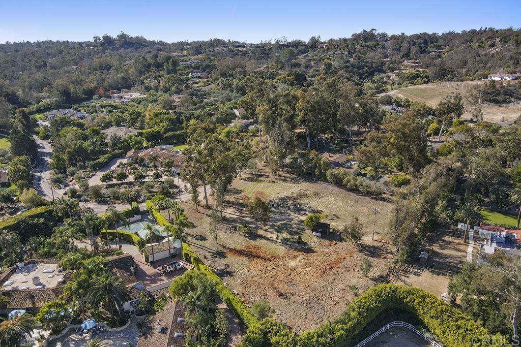 an aerial view of residential house with outdoor space and trees all around