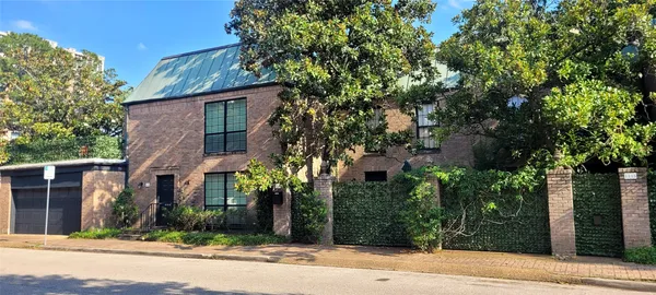front view of a house with a tree