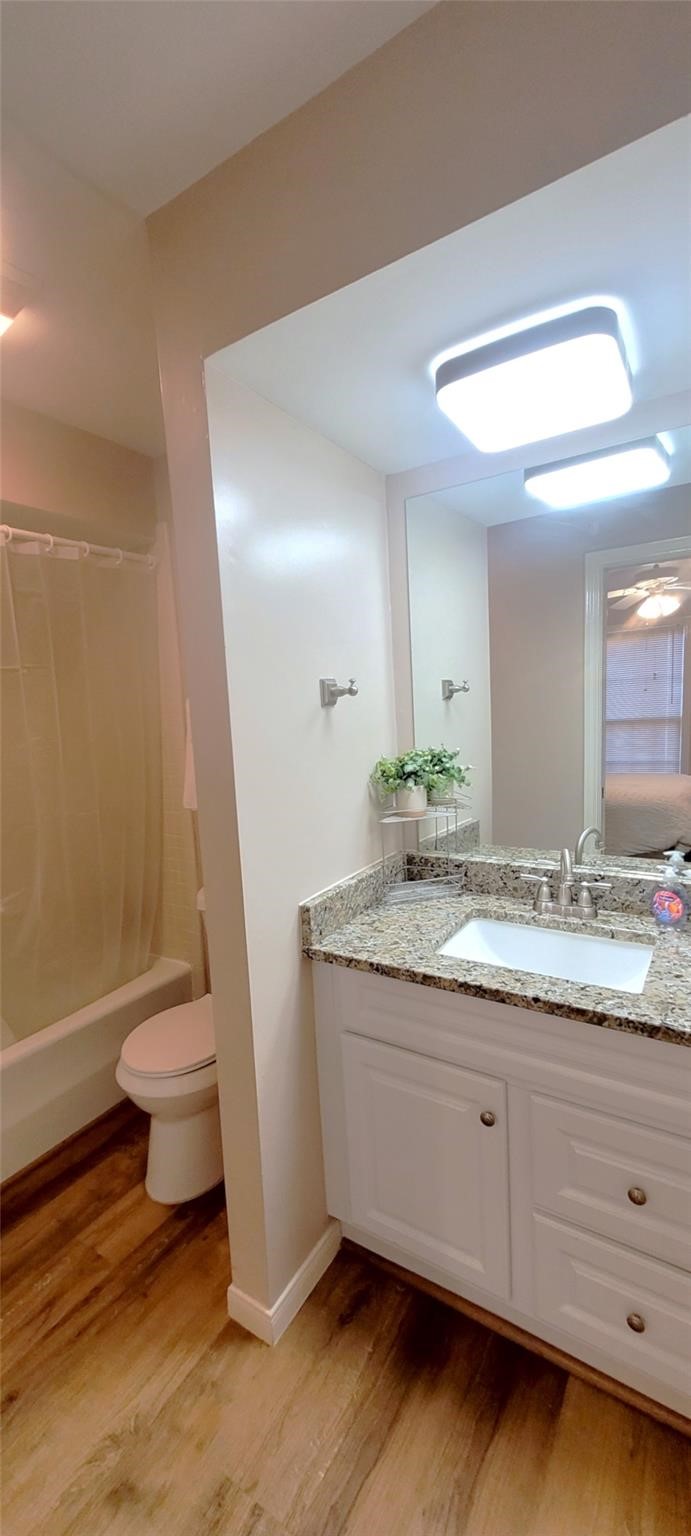 1111 Autrey Street, Unit 5 Houston, TX 77006 - Photo 22 of 33 a bathroom with a granite countertop toilet a sink and a mirror