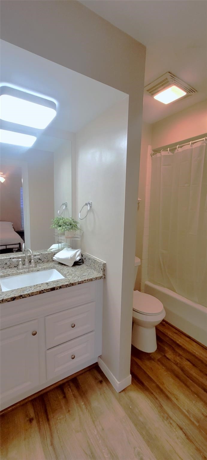 1111 Autrey Street, Unit 5 Houston, TX 77006 - Photo 30 of 33 a bathroom with a granite countertop sink a toilet and a shower