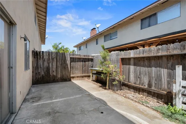 a view of backyard with small cabin and wooden fencing