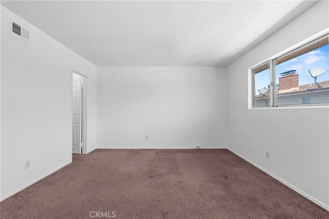 an empty room with a empty space and window
