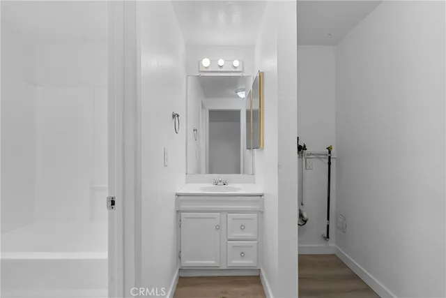 a bathroom with a sink a mirror and a bathtub