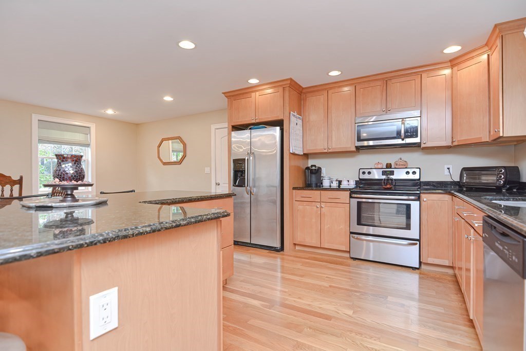 115 Bruce Road Walpole, MA 02081 - Photo 13 of 42 a kitchen with granite countertop a refrigerator stove top oven and sink