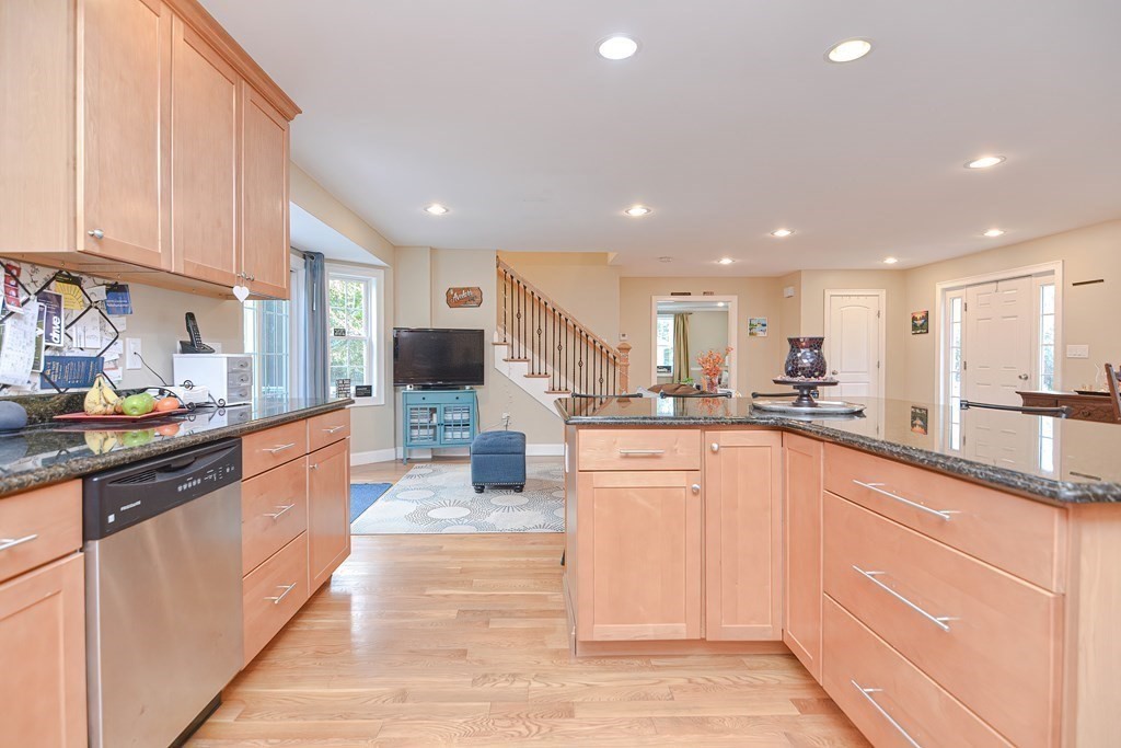 115 Bruce Road Walpole, MA 02081 - Photo 15 of 42 a large kitchen with stainless steel appliances kitchen island granite countertop a sink and cabinets