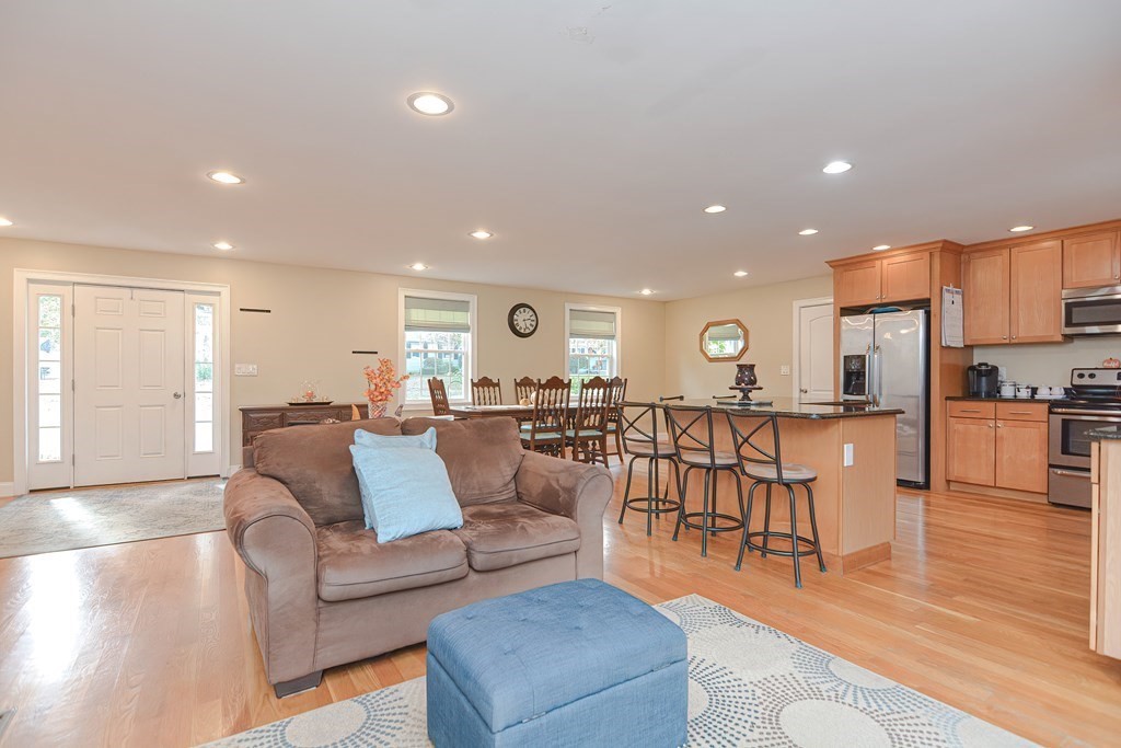 115 Bruce Road Walpole, MA 02081 - Photo 16 of 42 a living room with furniture kitchen view and a wooden floor