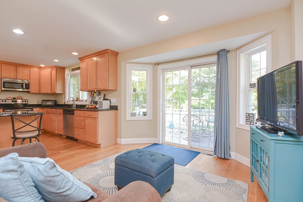 115 Bruce Road Walpole, MA 02081 - Photo 17 of 42 a living room with stainless steel appliances furniture and a flat screen tv
