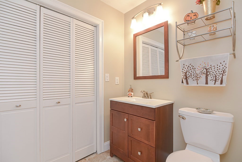115 Bruce Road Walpole, MA 02081 - Photo 21 of 42 a bathroom with a toilet a sink and a mirror