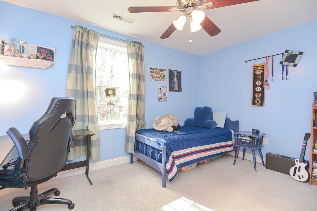 115 Bruce Road Walpole, MA 02081 - Photo 28 of 42 a bedroom with a bed and a chandelier