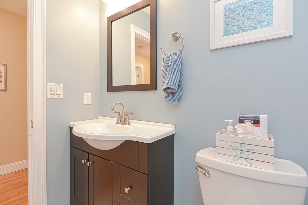 115 Bruce Road Walpole, MA 02081 - Photo 31 of 42 a bathroom with a sink toilet vanity and mirror