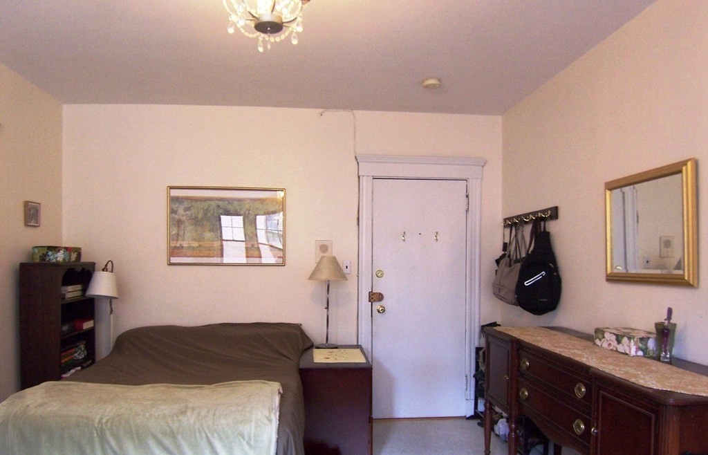 62 Queensberry Street, Unit 409 Boston, MA 02215 - Photo 2 of 5 a bedroom with a bed and wooden floor
