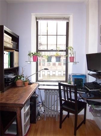 62 Queensberry Street, Unit 409 Boston, MA 02215 - Photo 3 of 5 a dining room with a window and wooden floor