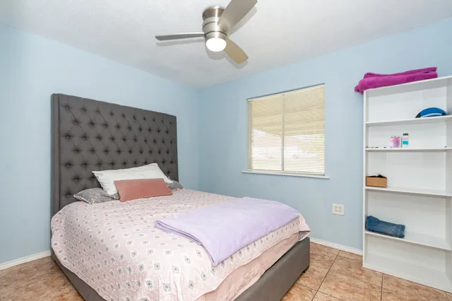 a bedroom with a bed and a window