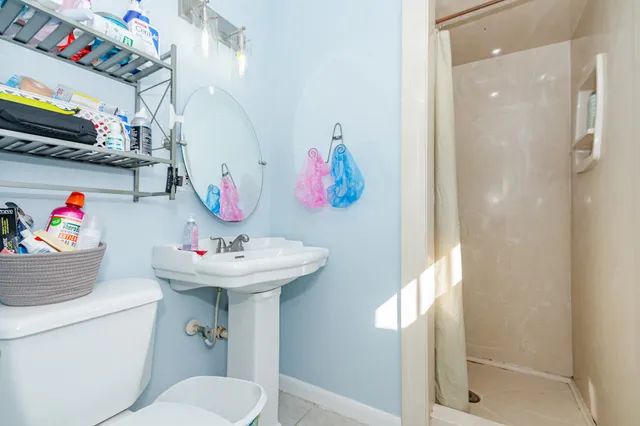 a bathroom with a toilet sink and mirror