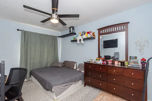 a bedroom with a bed and a dresser