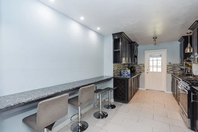 a kitchen with a sink cabinets and window