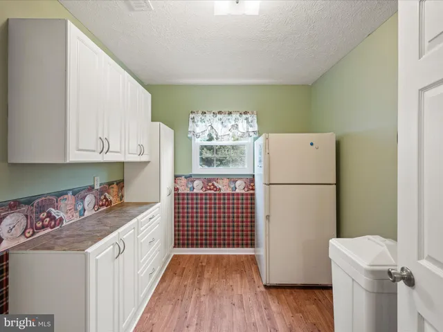 a kitchen with a refrigerator a stove a microwave and cabinets