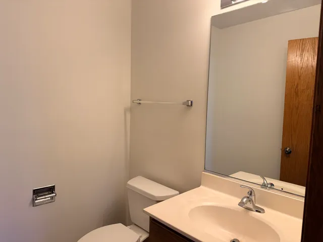 a bathroom with a sink a toilet and mirror