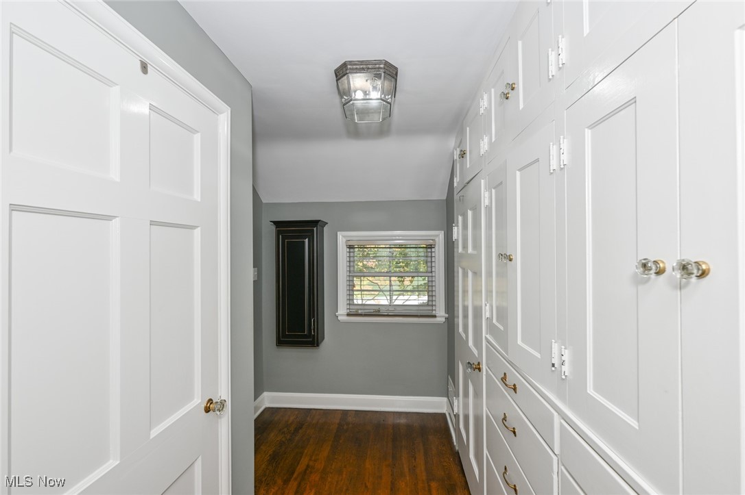 8960 Avery Road Broadview Heights, OH 44147 - Photo 27 of 50 Hallway featuring dark wood flooring, built in closets,cabinets