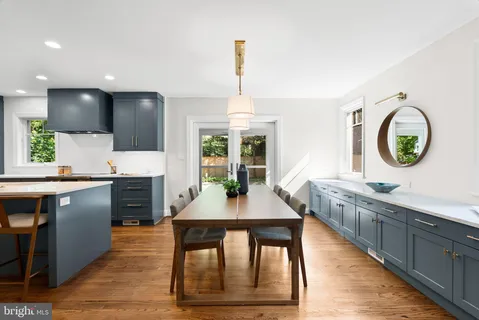 a kitchen with stainless steel appliances granite countertop a stove a sink and a wooden floors
