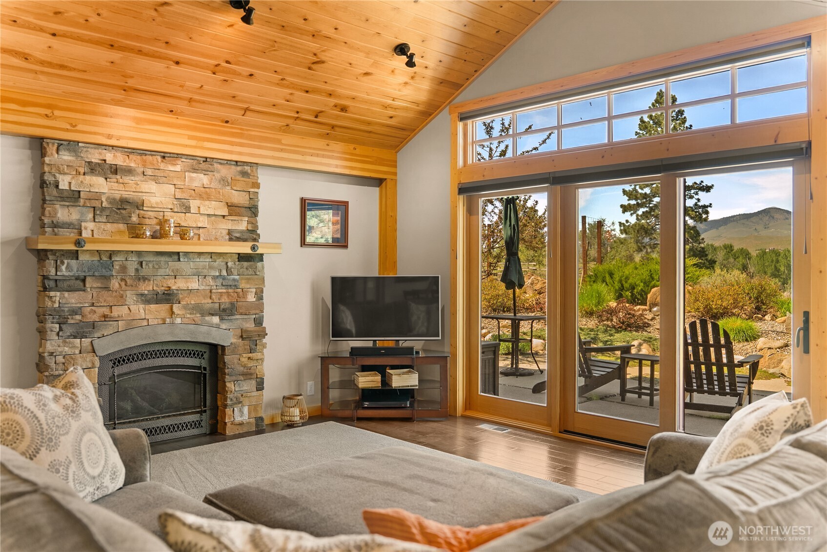 130 Sundown Road Winthrop, WA 98862 - Photo 15 of 40 a living room with furniture a flat screen tv and a fireplace
