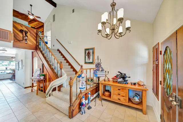 a view of a dining room with furniture and a chandelier