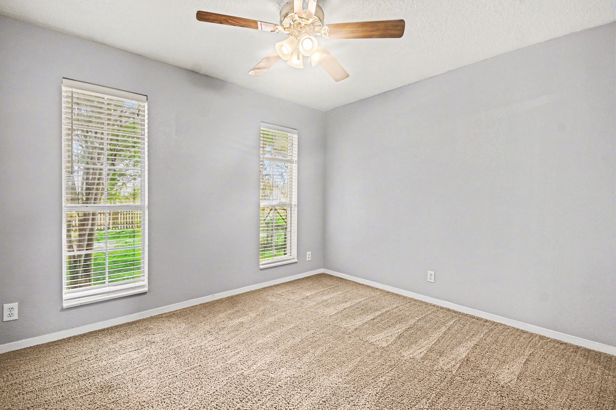 21503 Pecan Bend Road Damon, TX 77430 - Photo 23 of 45 an empty room with windows and fan