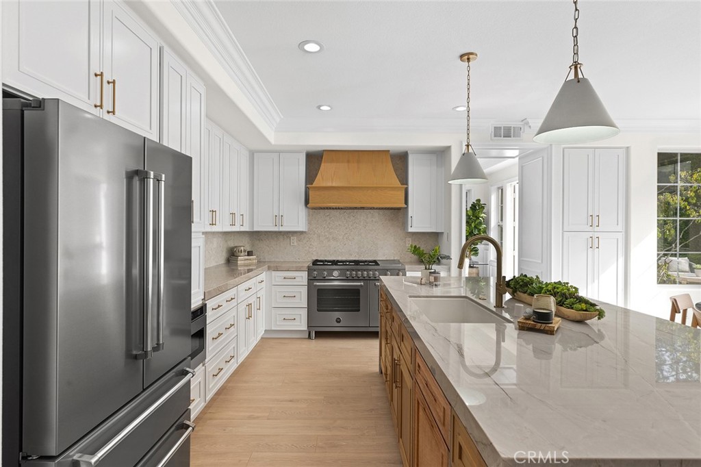 16 Meryton Irvine, CA 92603 - Photo 13 of 54 a kitchen with stainless steel appliances granite countertop a sink a stove and a refrigerator